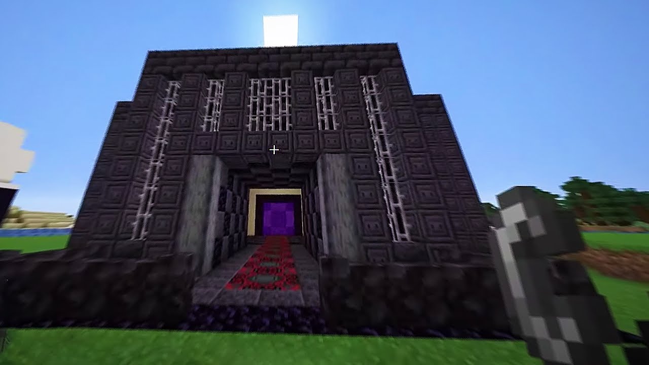 A screenshot from presumably Sam's stream. It also shows the entrance to the prison except now, Sam holds a flint and steel and the entrance portal is lit.